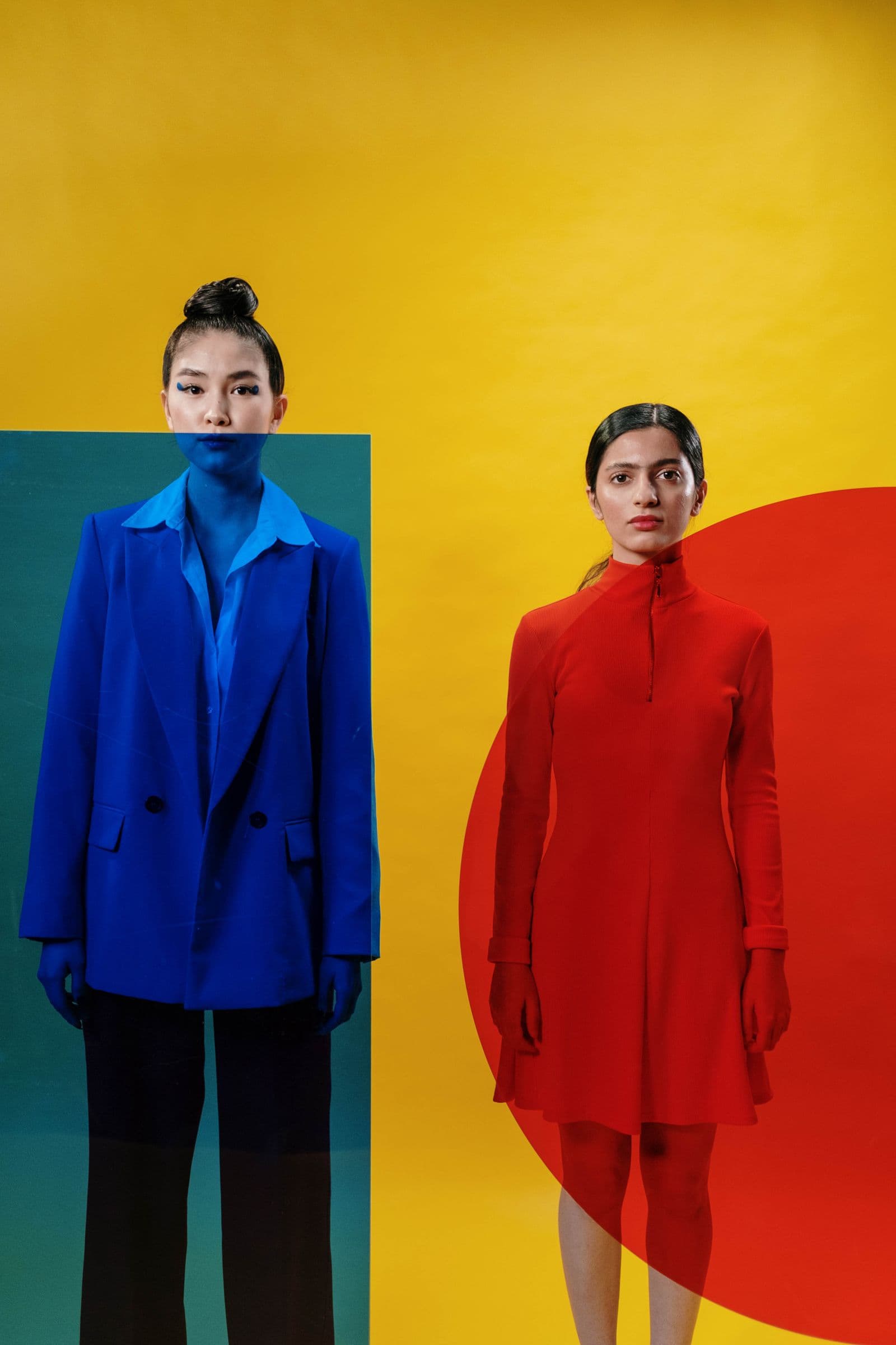 Two modern creators in a bold editorial studio portrait